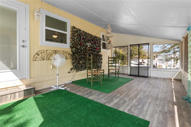 unfurnished sunroom featuring vaulted ceiling