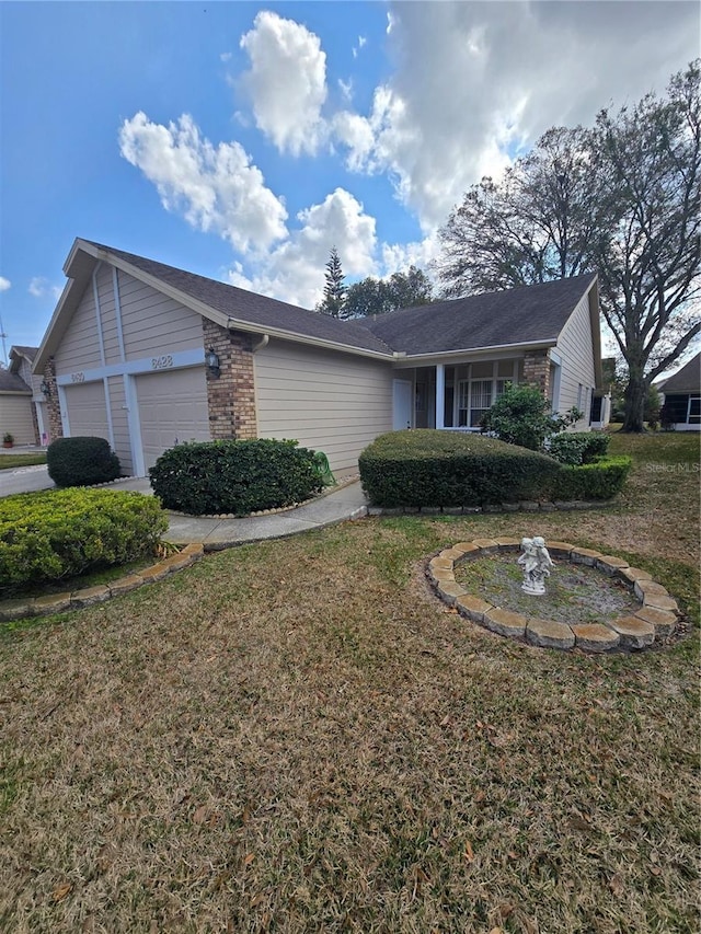 view of side of property featuring a garage and a yard