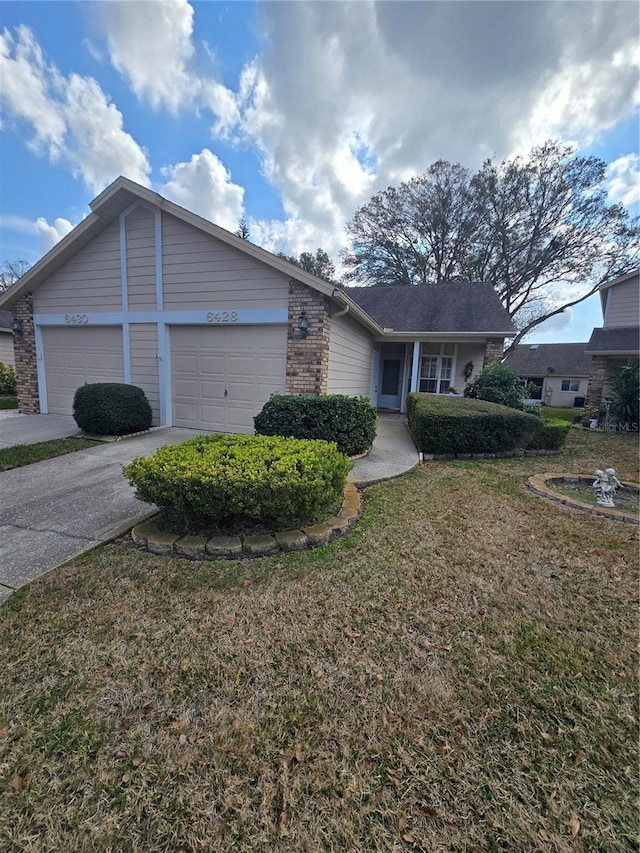 ranch-style house with a garage and a front lawn