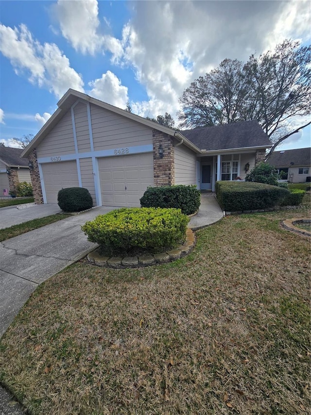 single story home featuring a garage and a front lawn