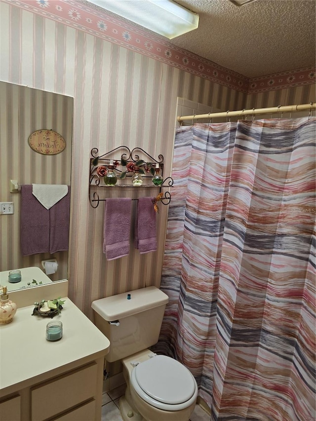 bathroom featuring walk in shower, vanity, toilet, and a textured ceiling