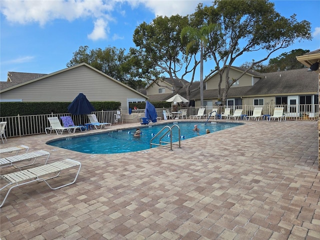 view of swimming pool with a patio area