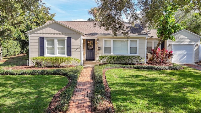 single story home with a garage and a front yard