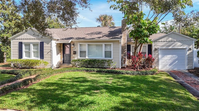 ranch-style house featuring a garage and a front lawn