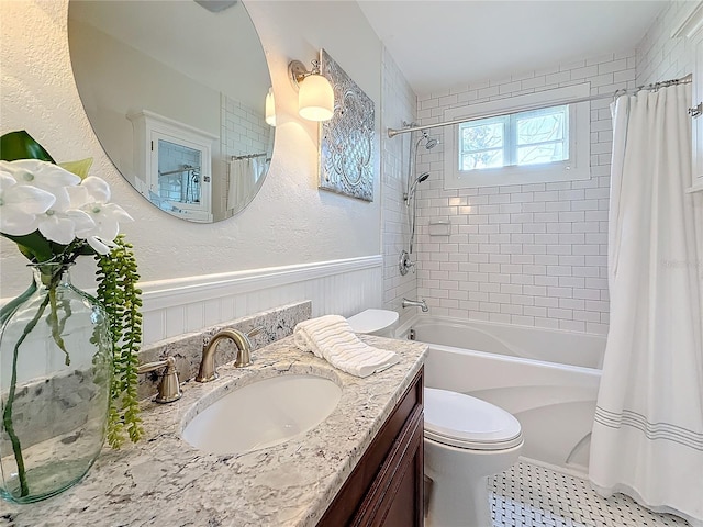 full bathroom featuring vanity, shower / bath combo, and toilet