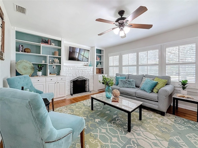 living room featuring light hardwood / wood-style flooring and ceiling fan