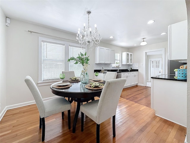 dining space featuring a chandelier and light wood-type flooring