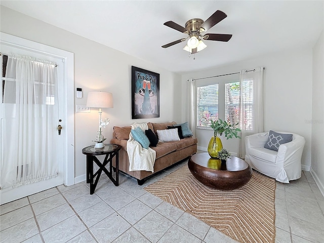 tiled living room with ceiling fan