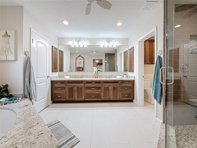 full bathroom with vanity, separate shower and tub, ceiling fan, toilet, and a textured ceiling