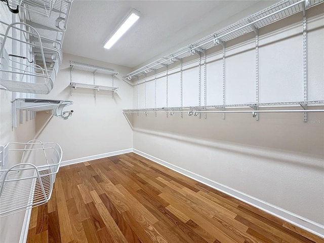 spacious closet featuring hardwood / wood-style floors