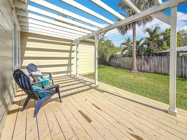 deck featuring a pergola and a lawn