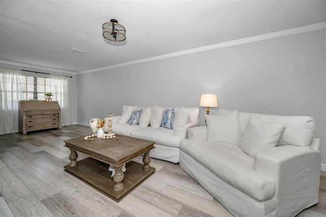 living room with ornamental molding and light hardwood / wood-style floors