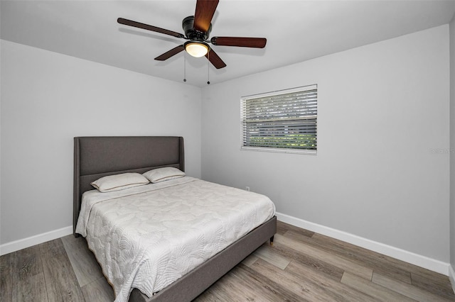 bedroom with wood-type flooring and ceiling fan