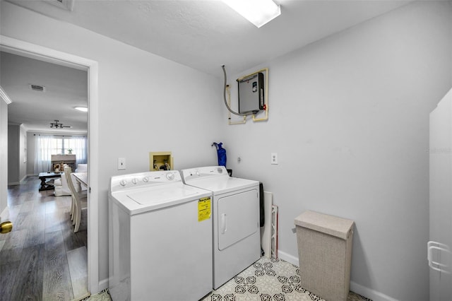 washroom with washer and dryer and light wood-type flooring