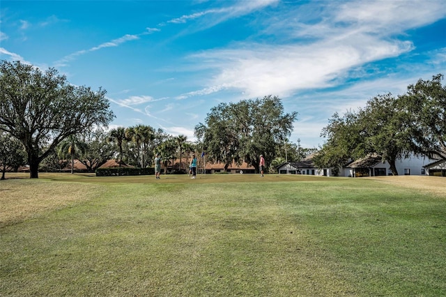 view of property's community featuring a yard