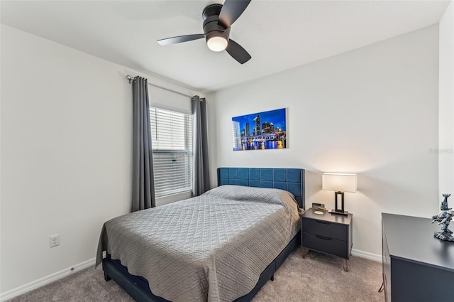 bedroom featuring light colored carpet and ceiling fan