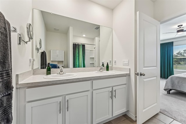 bathroom with walk in shower, vanity, and tile patterned flooring