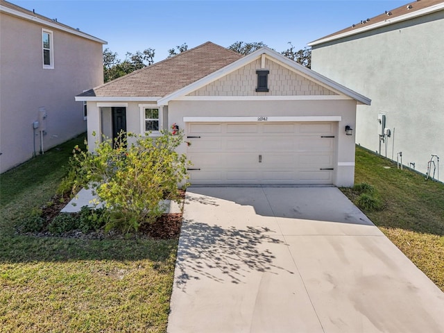 view of front of home with a garage and a front lawn