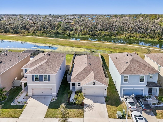 birds eye view of property with a water view