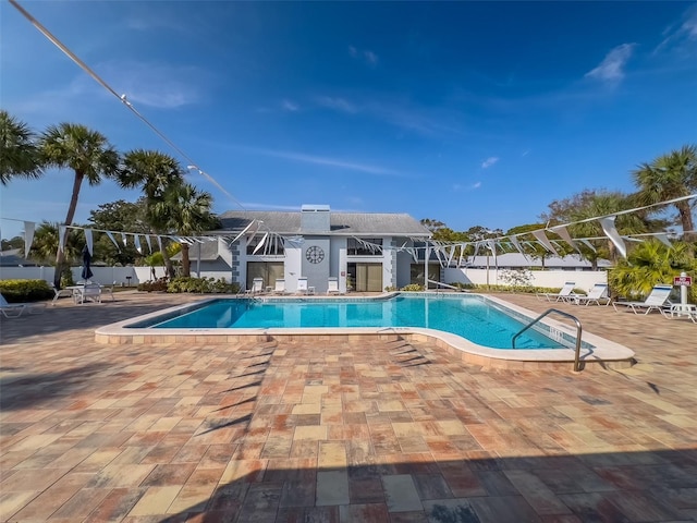 community pool featuring a patio area and fence