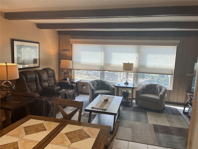 tiled living room with wooden walls, beam ceiling, and a textured ceiling