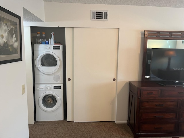 laundry area featuring stacked washer and dryer