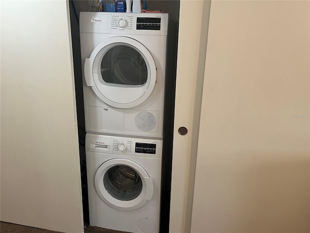 washroom featuring stacked washer / dryer