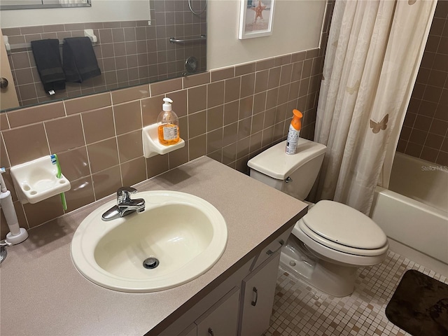 full bathroom featuring shower / bath combo, tile walls, vanity, tile patterned floors, and toilet