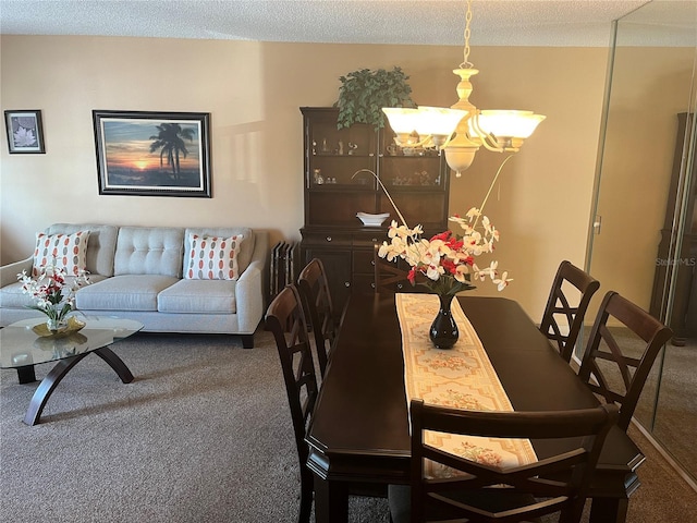 dining room featuring a textured ceiling, a notable chandelier, and dark carpet