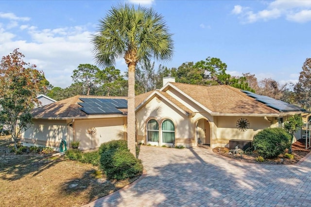 view of front of house featuring a garage and solar panels