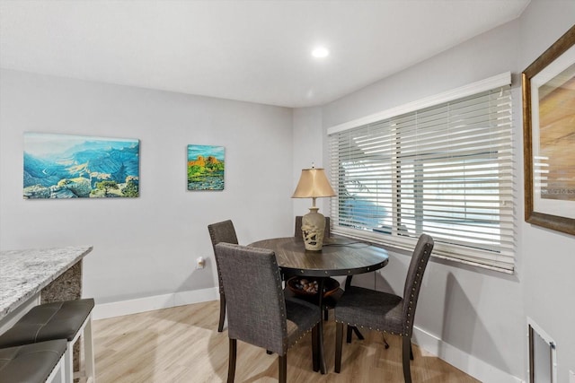 dining space with light wood-type flooring