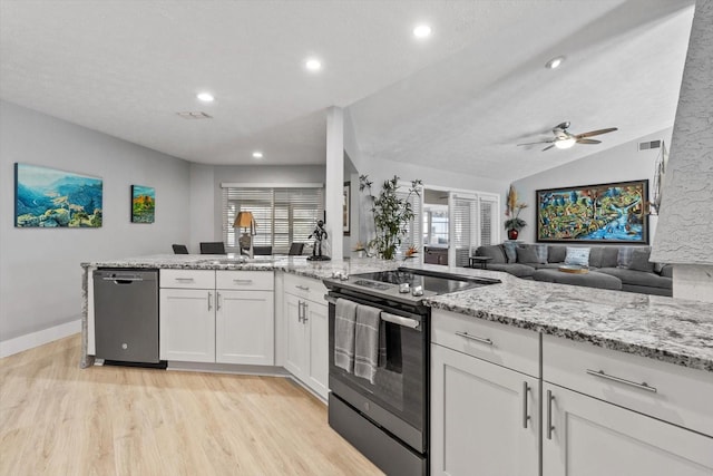 kitchen featuring electric range oven, white cabinets, stainless steel dishwasher, light stone counters, and light hardwood / wood-style floors