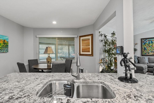 kitchen with light stone counters and sink