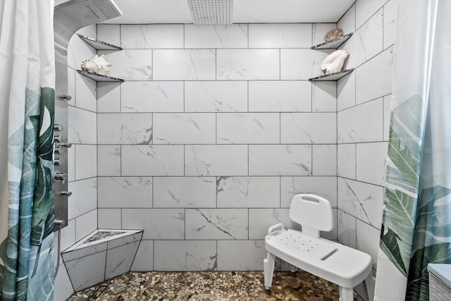 bathroom with a tile shower