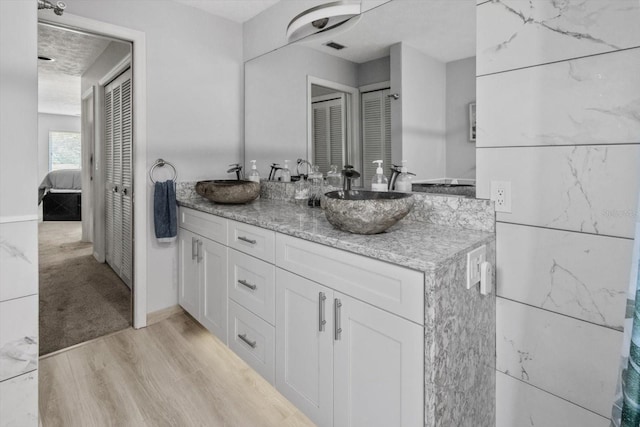 bathroom featuring vanity and wood-type flooring