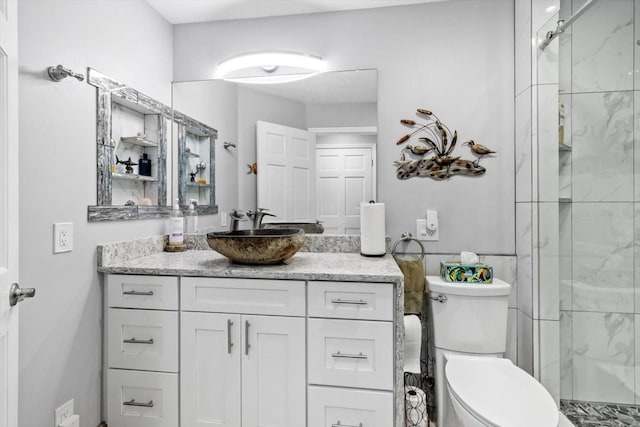 bathroom featuring vanity, a shower with door, and toilet