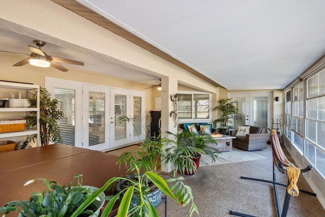 sunroom / solarium with ceiling fan and french doors