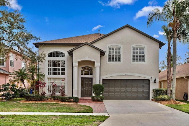 view of front of property with a garage and a front yard