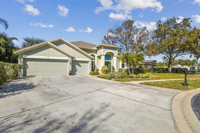 view of front of house featuring a garage and a front lawn