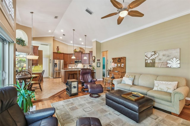 living room featuring ceiling fan, ornamental molding, high vaulted ceiling, and light hardwood / wood-style floors