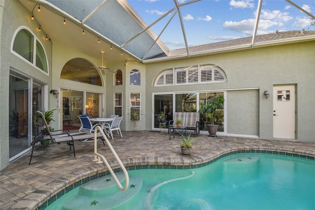 view of pool featuring a patio area and glass enclosure