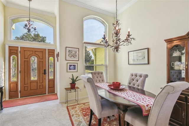 tiled dining area featuring a high ceiling, ornamental molding, a wealth of natural light, and an inviting chandelier