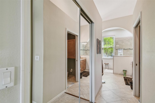 corridor featuring light tile patterned floors