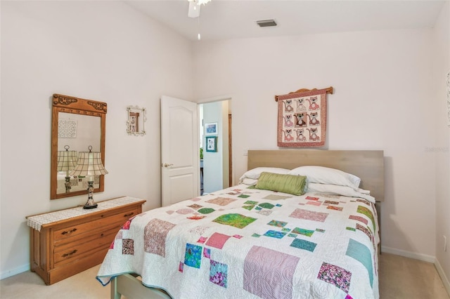 bedroom with vaulted ceiling and light colored carpet