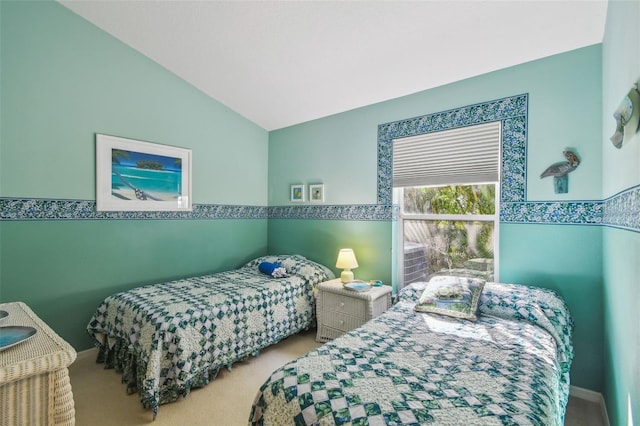 carpeted bedroom with lofted ceiling