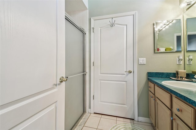 bathroom with vanity, an enclosed shower, and tile patterned floors