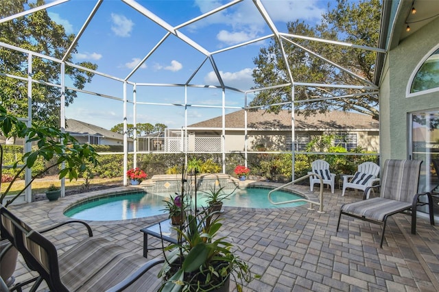 view of swimming pool featuring a patio and glass enclosure