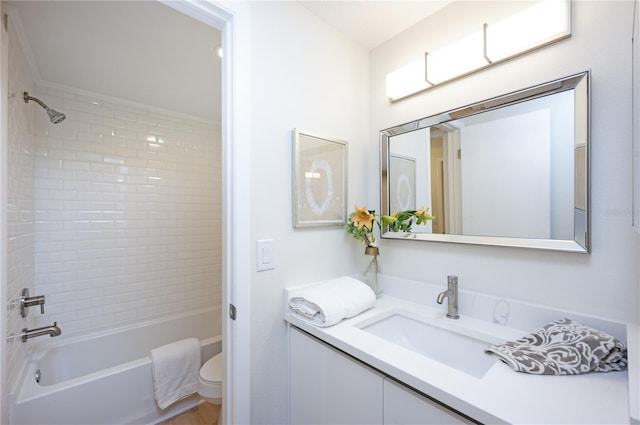 full bathroom featuring vanity, toilet, and tiled shower / bath