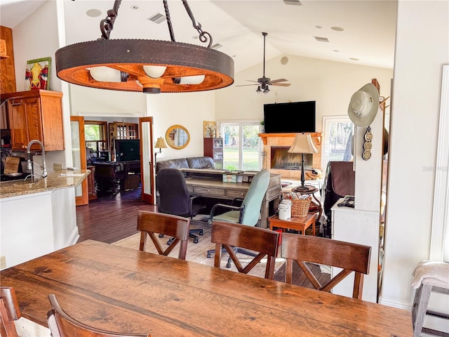 dining area featuring ceiling fan, dark hardwood / wood-style floors, and high vaulted ceiling