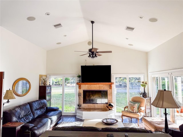 living room featuring hardwood / wood-style flooring, vaulted ceiling, and ceiling fan